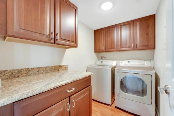 a utility room with sink dryer and washer