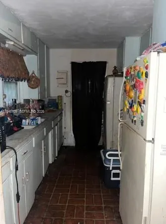 a kitchen with a refrigerator and a stove