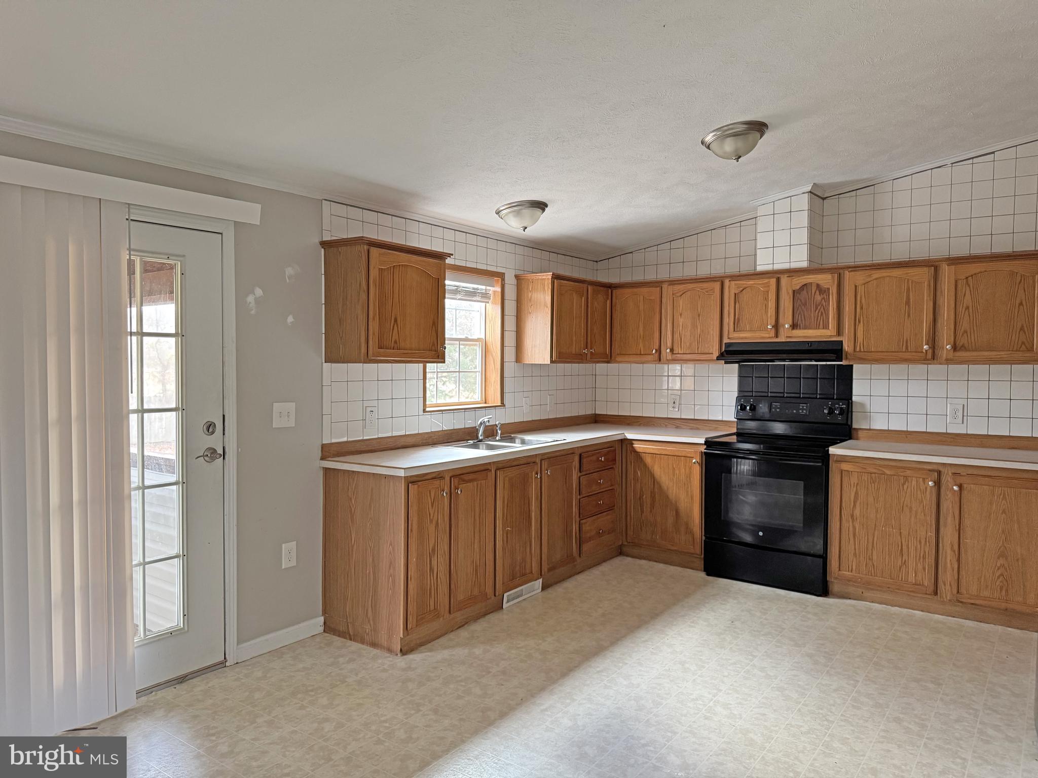 238 Silver Leaf Lane Dover, DE 19901 - Photo 5 of 20 a kitchen with granite countertop a stove top oven sink and cabinets