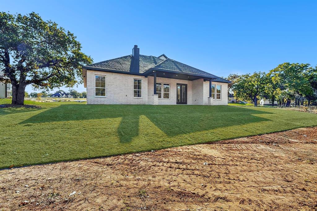 1161 Gonzollas Road Springtown, TX 76082 - Photo 38 of 40 a front view of a house with a yard