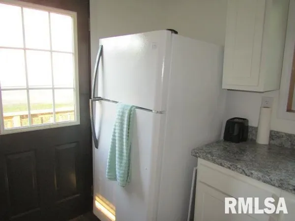 a kitchen with granite countertop white cabinets stainless steel appliances and sink