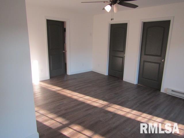 1506 Hillside Road Rosiclare, IL 62982 - Photo 7 of 29 an empty room with wooden floor and ceiling fan