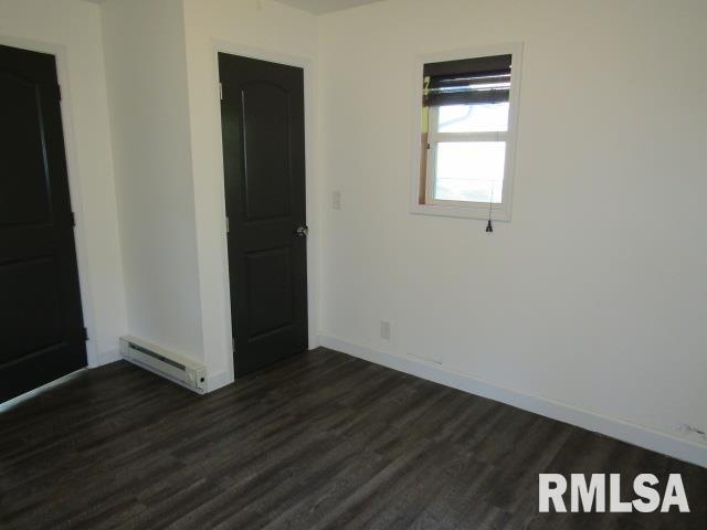 1506 Hillside Road Rosiclare, IL 62982 - Photo 8 of 29 an empty room with wooden floor and windows