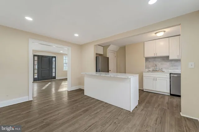 a view of kitchen with cabinets and wooden floor