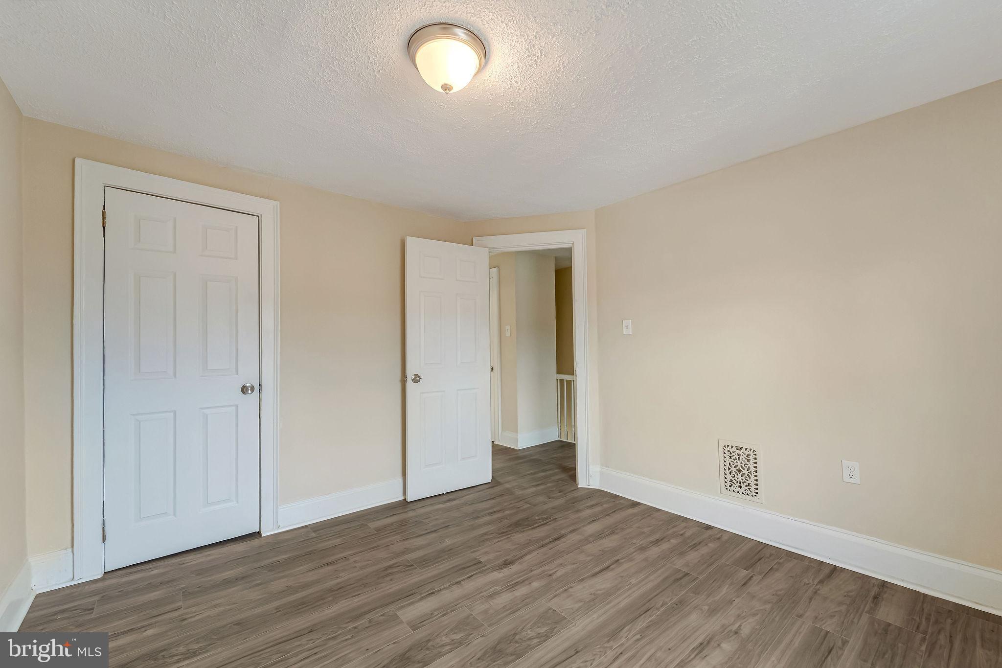 1029 Ironside Road Camden, NJ 08104 - Photo 15 of 25 an empty room with wooden floor and windows
