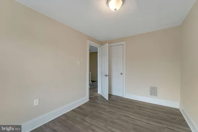 a view of an empty room and wooden floor