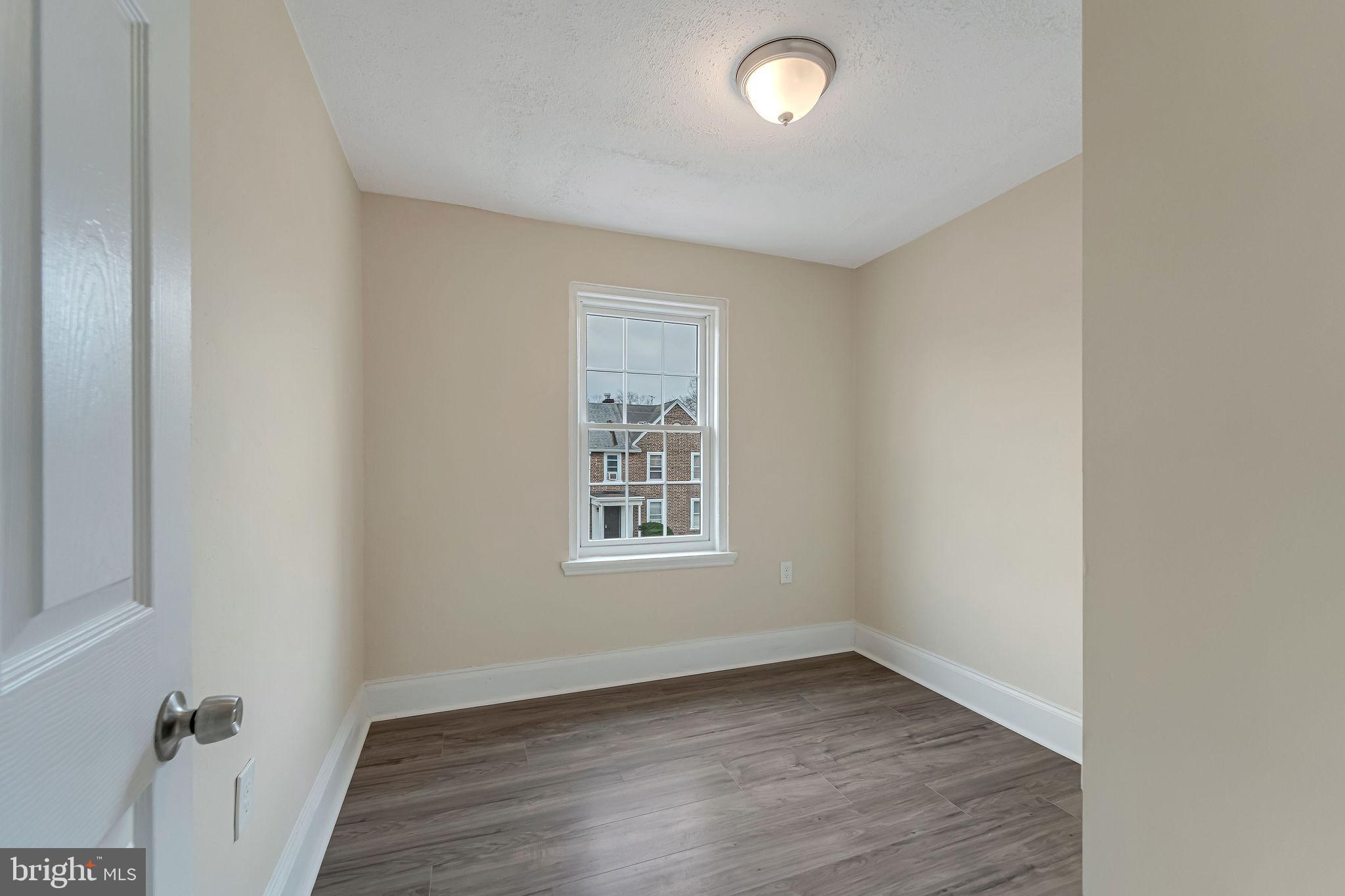 1029 Ironside Road Camden, NJ 08104 - Photo 18 of 25 an empty room with wooden floor and windows