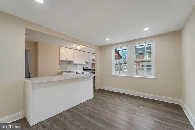 a view of kitchen with sink and wooden floor