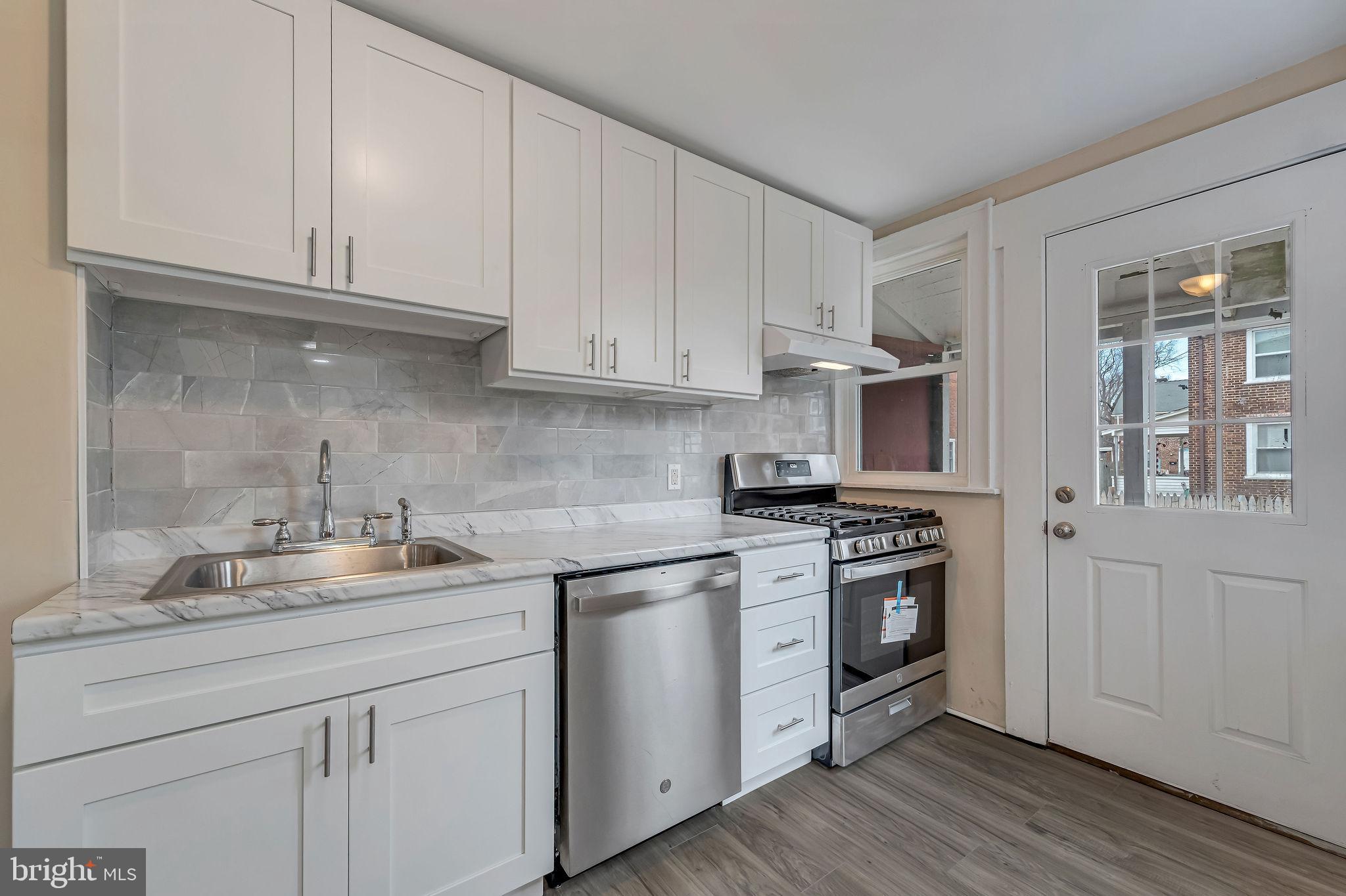1029 Ironside Road Camden, NJ 08104 - Photo 8 of 25 a kitchen with stainless steel appliances granite countertop a sink and stove top oven