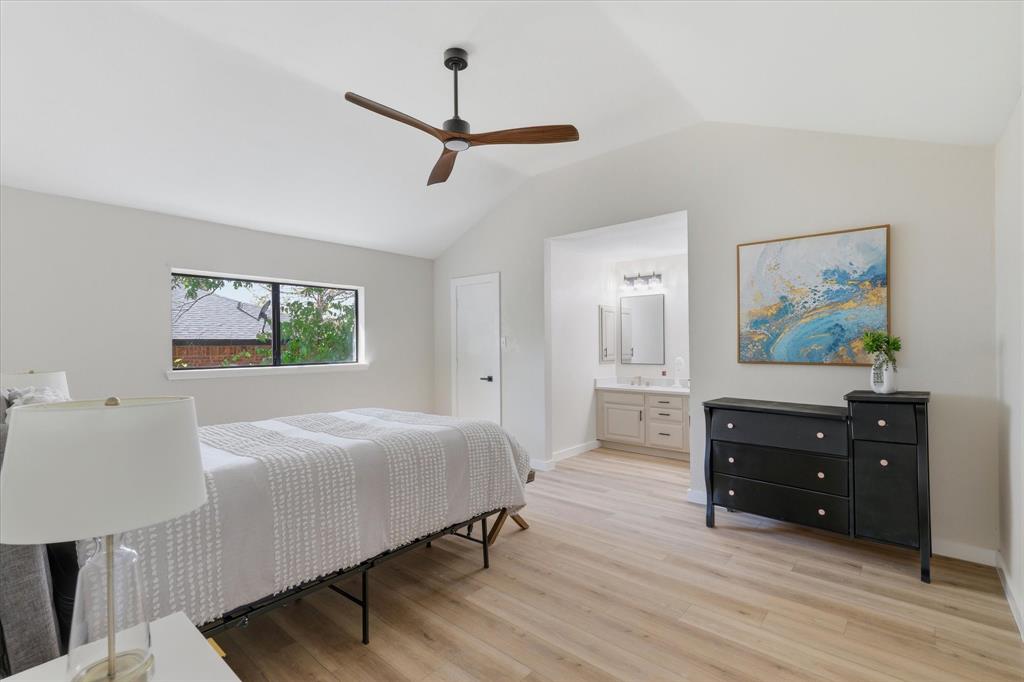 3405 Mill Ridge Street Bedford, TX 76021 - Photo 17 of 32 Vaulted ceilings with a ceiling fan, recessed window, wood-finish flooring, and an en-suite vanity with a single sink