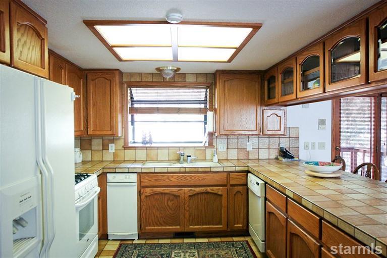 272 Chimney Rock Road Stateline, NV 89449 - Photo 25 of 35 a kitchen with stainless steel appliances granite countertop a sink stove and refrigerator