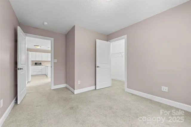 an empty room with closet and a bathroom