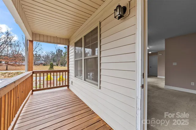 a view of a balcony with wooden floor