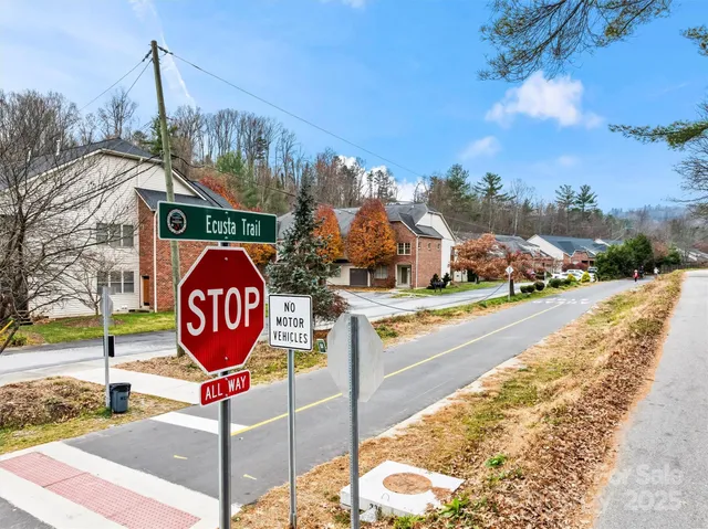 a view of a park with iron fence