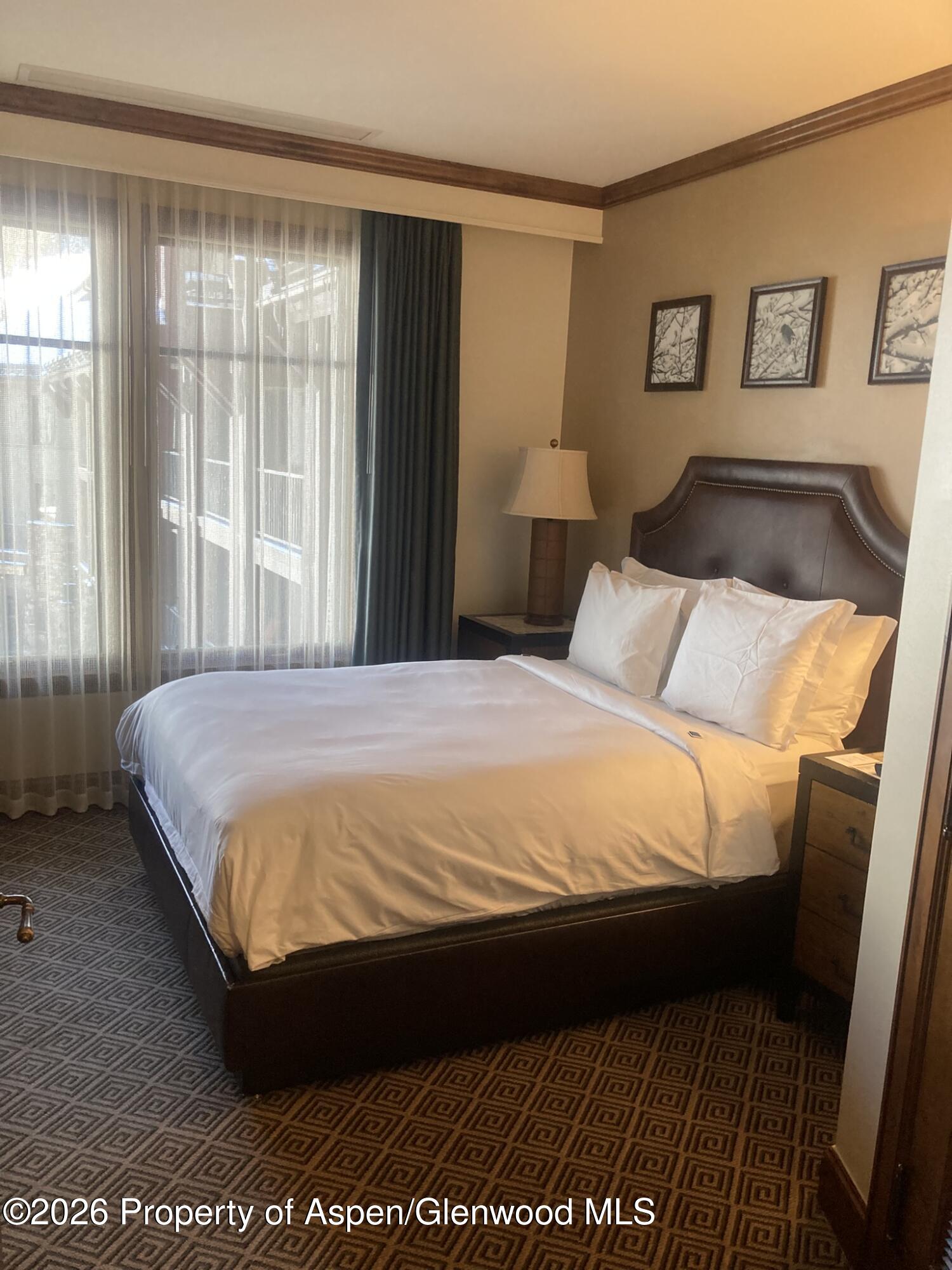 39 Boomerang Road, Unit 82104 Aspen, CO 81611 - Photo 11 of 22 a bedroom with a bed and a window