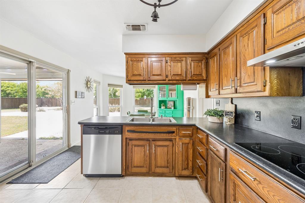 5 Orchard Road Lucas, TX 75002 - Photo 6 of 34 Spacious kitchen featuring warm wood cabinetry and dark countertops