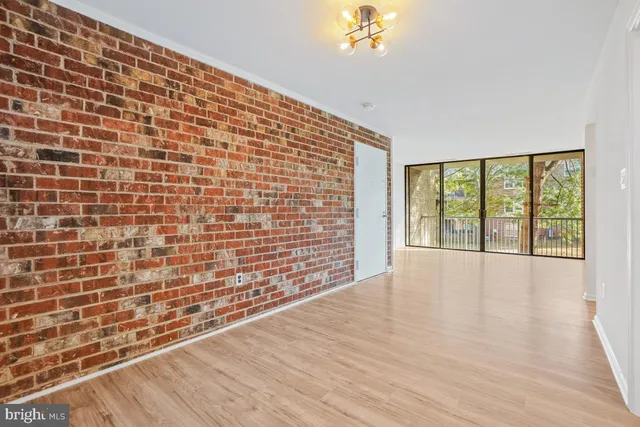 a view of an empty room and wooden floor