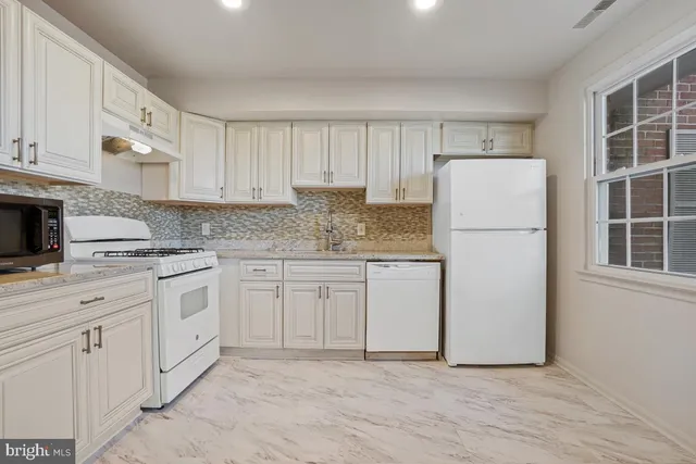 a kitchen with appliances cabinets and a sink