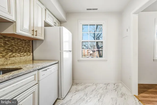 a kitchen with a refrigerator and window