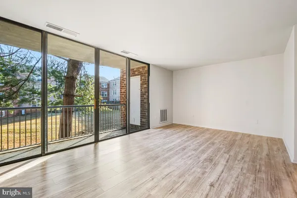 a view of an empty room and glass door