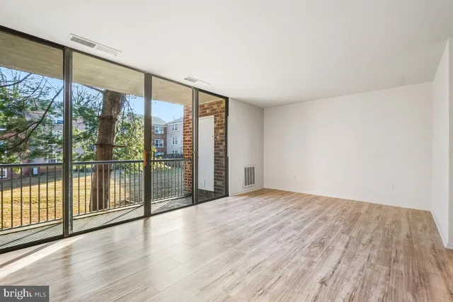 a view of an empty room and glass door