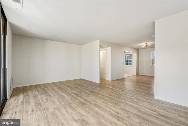 a view of an empty room and wooden floor