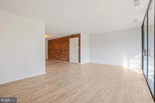 a view of an empty room and wooden floor