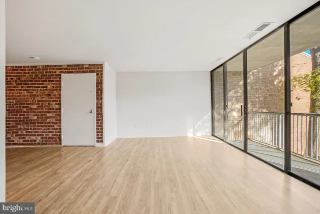 wooden floor in an empty room with a window