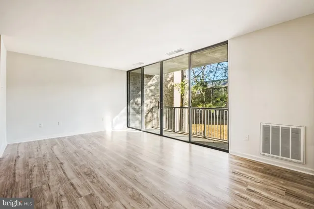 wooden floor in an empty room with a window