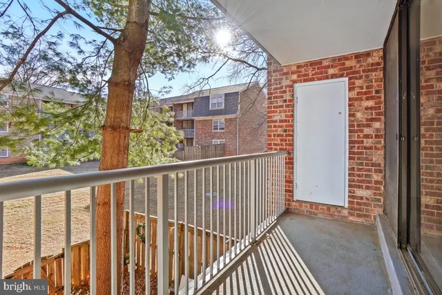 a view of a balcony with wooden floor and fence