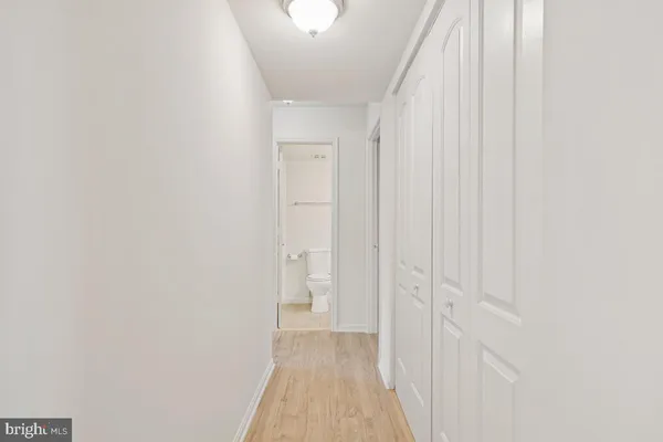 a view of a hallway with wooden floor