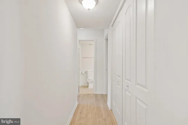 a view of a hallway with wooden floor