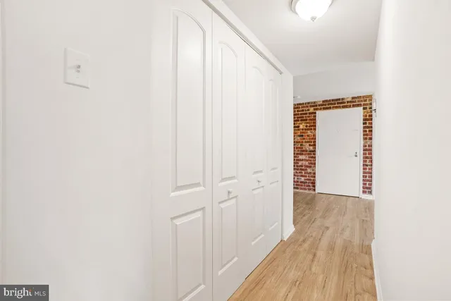 a view of a hallway with wooden floor