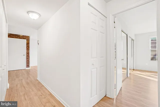 a view of a hallway with wooden floor