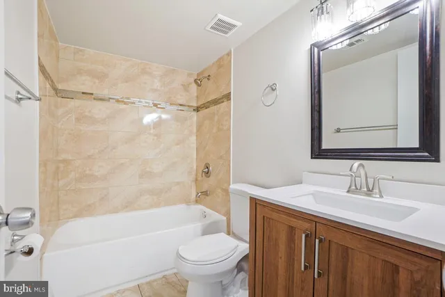a bathroom with a sink a toilet and a bathtub