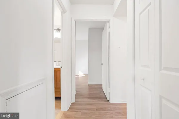 a view of a hallway with wooden floor