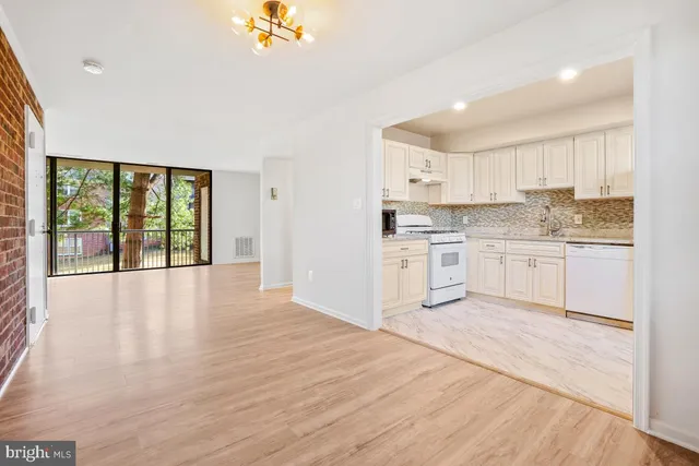 a view of large kitchen with granite countertop cabinets and outdoor space