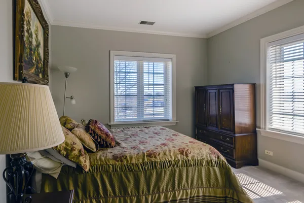 a bed sitting in a bedroom next to a window