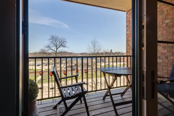 a view of a balcony with a couple of chairs