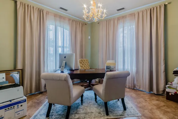 a view of a dining room with furniture and a window