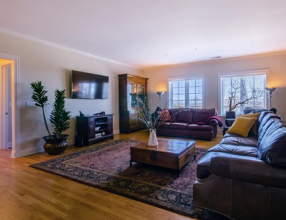a living room with furniture window and a flat screen tv