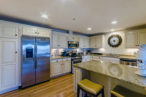 a large kitchen with a table and chairs in it
