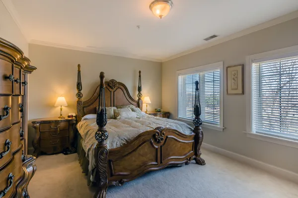 a bed sitting in a bedroom next to a window