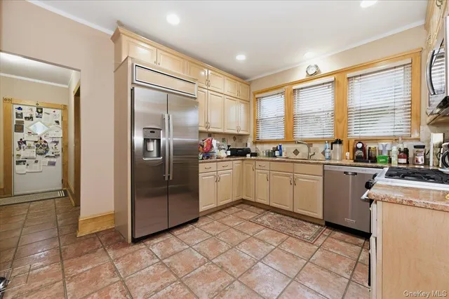 a kitchen with stainless steel appliances a refrigerator sink and cabinets