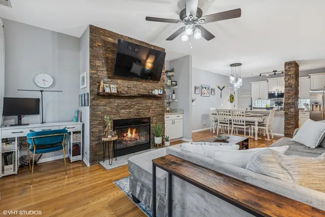 a living room with furniture fireplace and flat screen tv