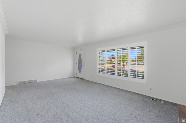 148 Tennyson Avenue Sandy, UT 84070 - Photo 7 of 55 Bright room with neutral wall tones and a textured gray carpet