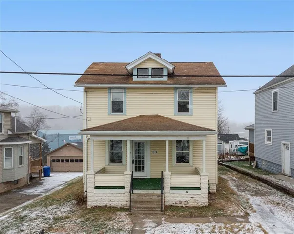 a front view of a house with a yard and balcony