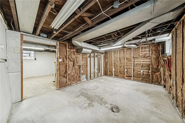 a view of empty room with wooden walls