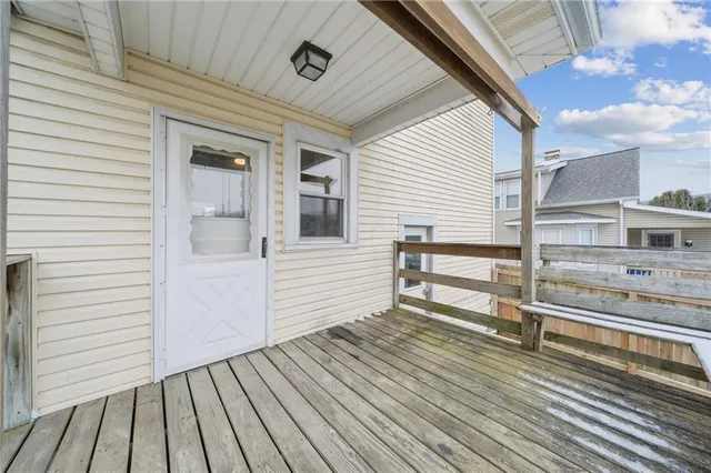 a view of a house with wooden deck