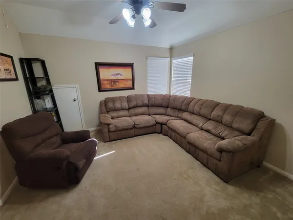a living room with furniture a couch and a chandelier